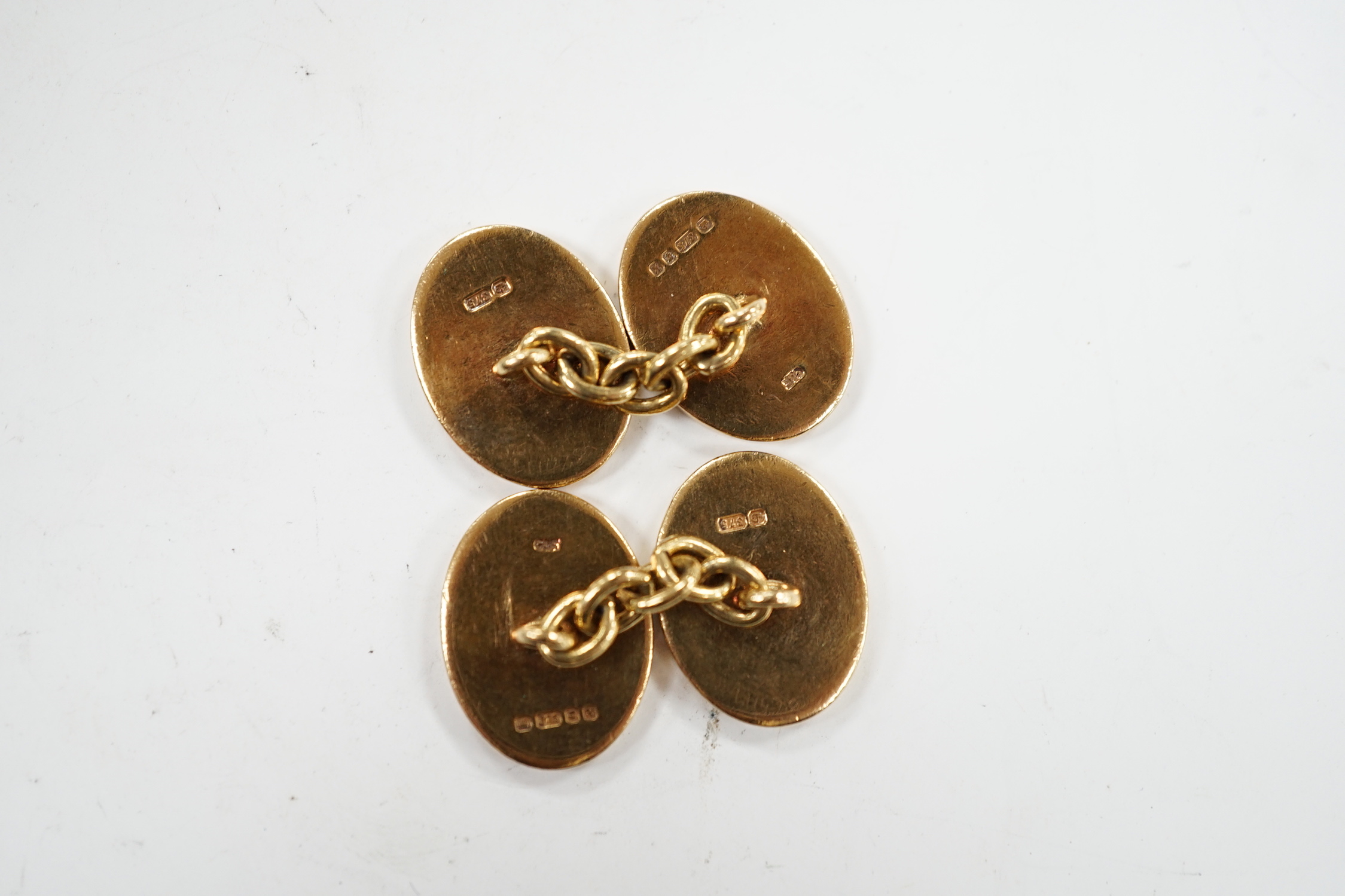 A pair of early 1960's 9ct gold oval cufflinks, with engraved crest and monogram, 10.3 grams.